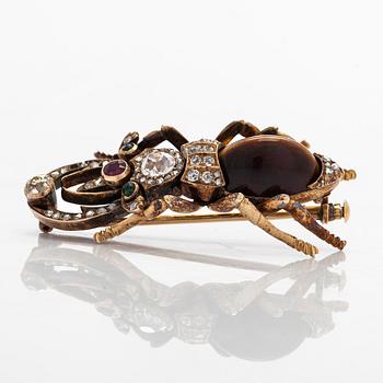 A 14K gold brooch with tiger’s eye, old-cut and rose-cut diamonds, ruby, emeralds. St. Petersburg.