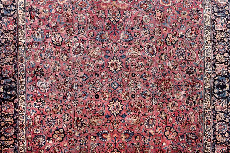 An antique Mashad carpet, signed Saber, c. 405 x 295 cm.