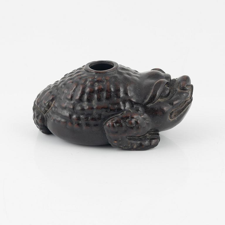 A wooden brushpot in the shape of a three legged toad, China, 20th Century.