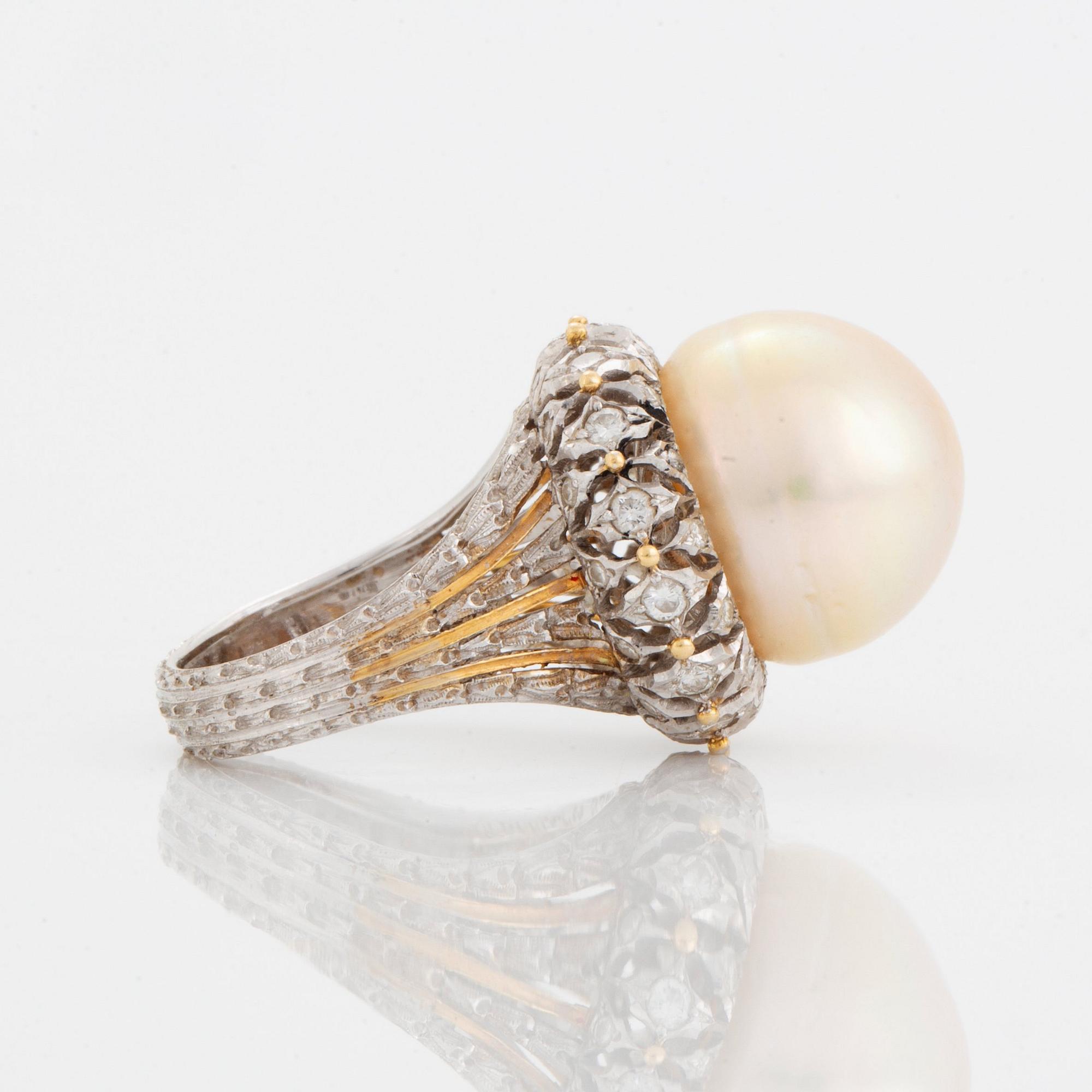 An 18K gold ring set with a cultured pearl and round brilliant-cut diamonds.