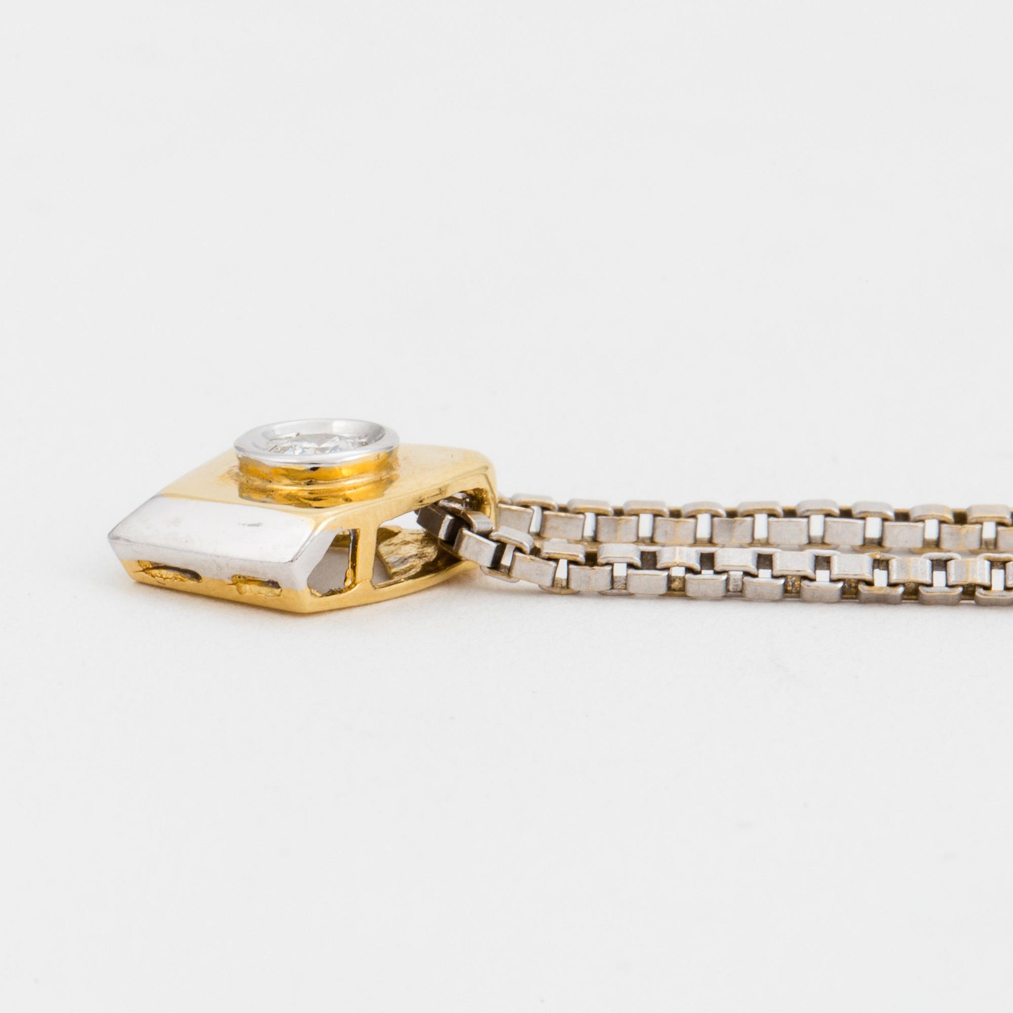 A chain and a pendant set with a round, brilliant-cut diamond.