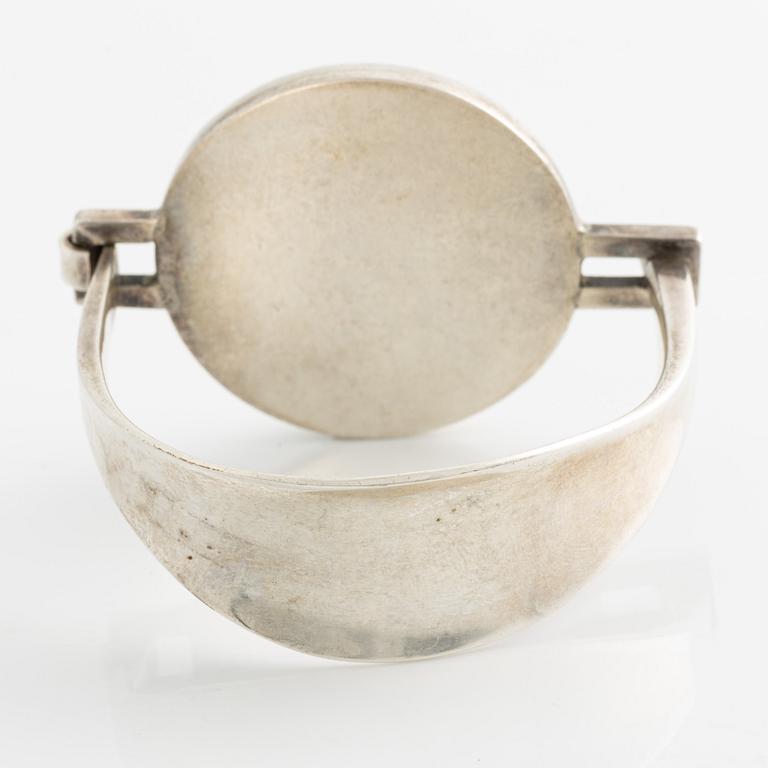 Bangle, silver with inset stone/flower.