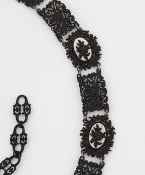 A Berlin steel and iron parure comprising a necklace, two bracelets and a brooch.