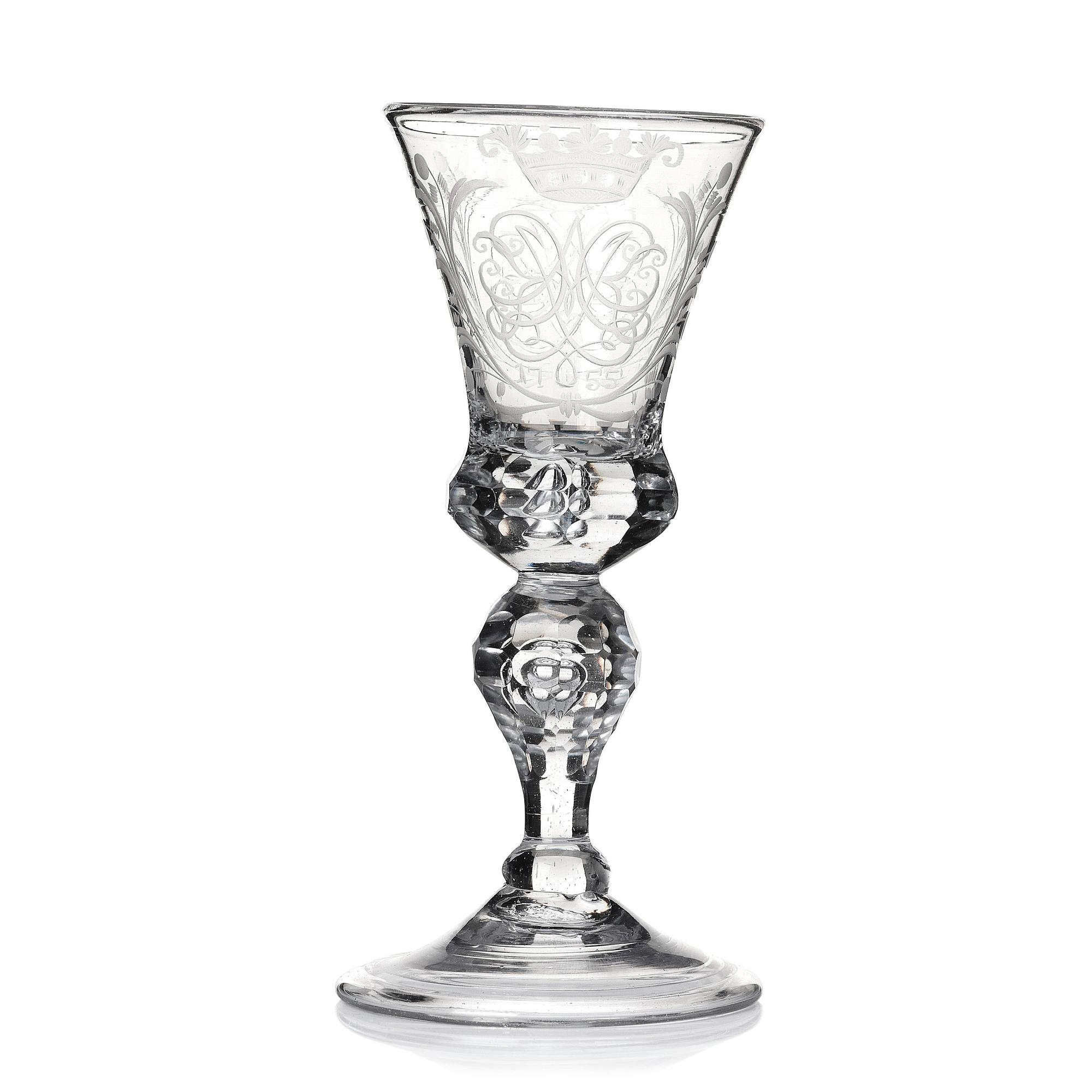 A cut and engraved glass goblet, dated 1755.