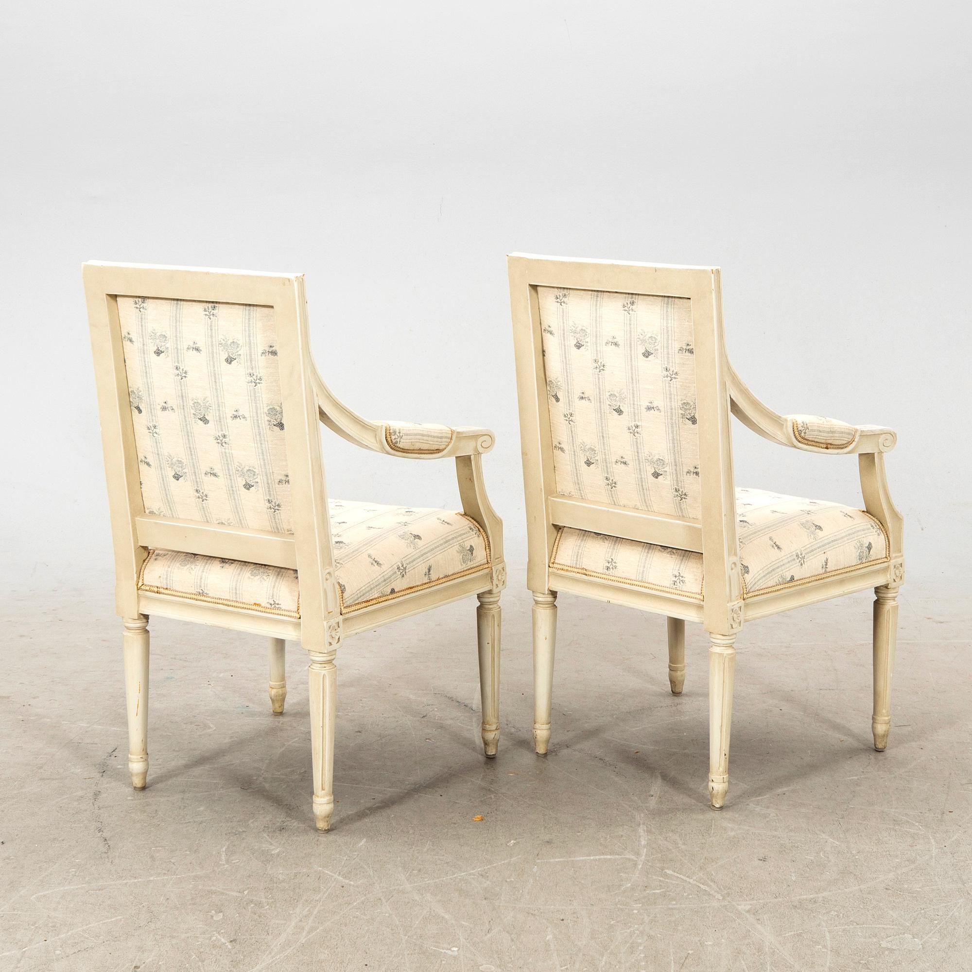 A pair of Gustavian style painted armchairs from around 1900.