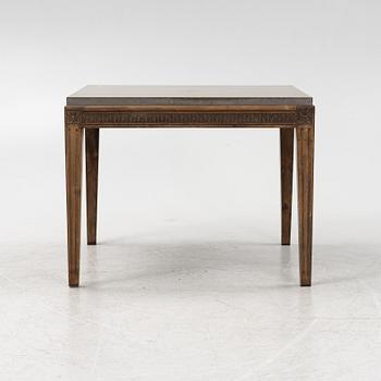 A Louis XVI style coffee table with a limestone top.