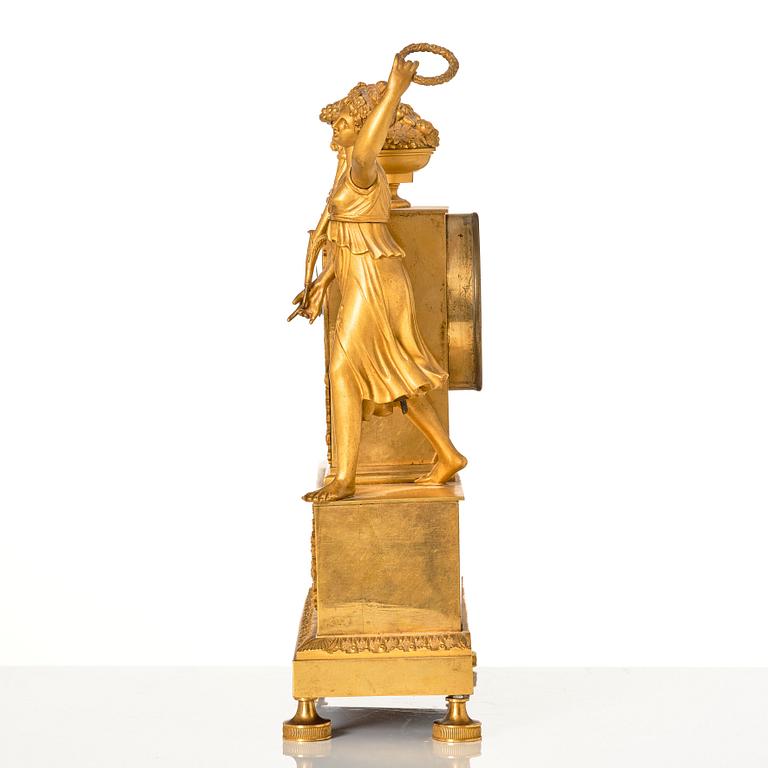 An Empire ormolu figural mantel clock, early 19th century.