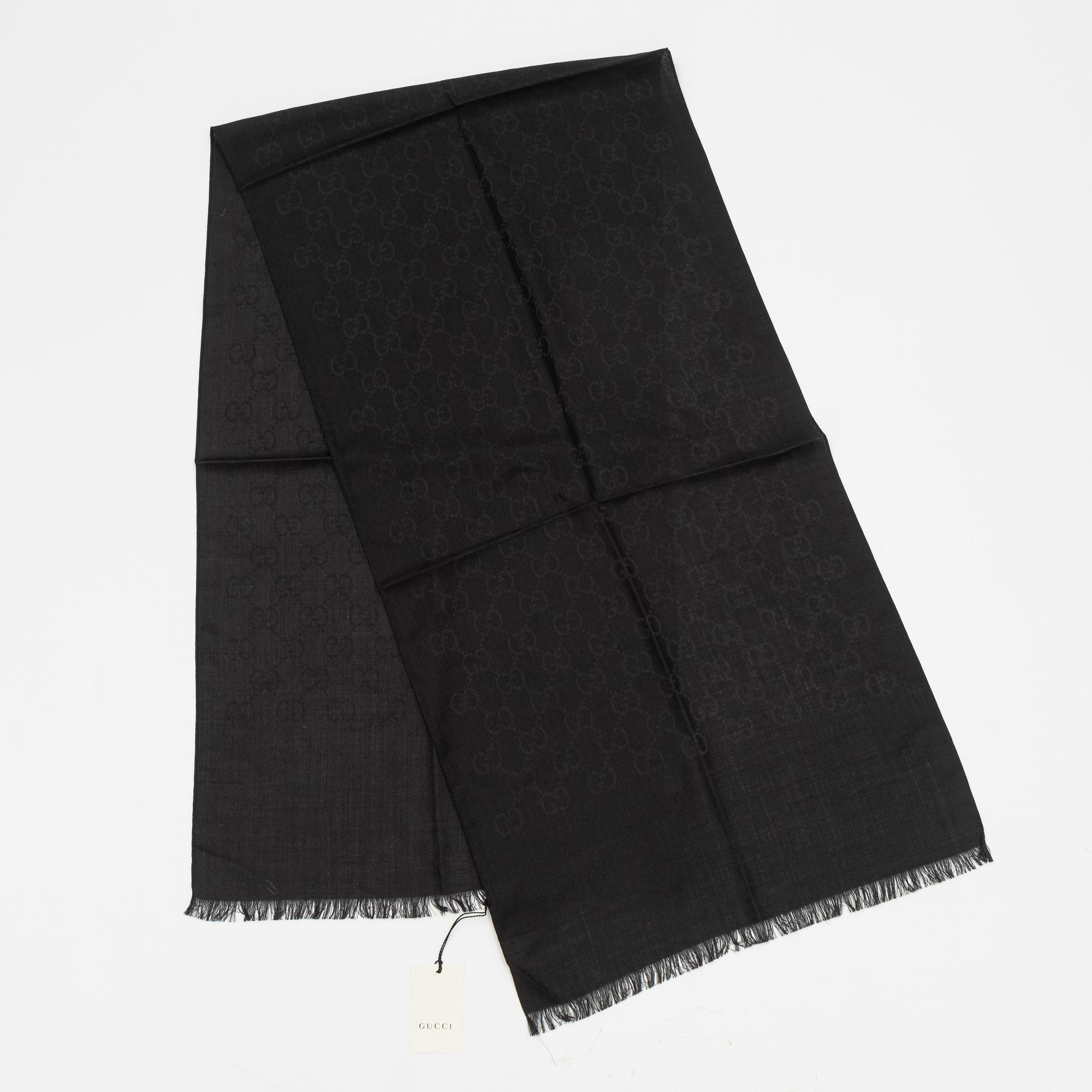 Gucci, a wool and silk mix "GG" jaquard shawl.
