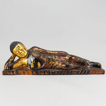 A large gilt and lacquered figure of reclining buddha, Thailand, circa 1900.
