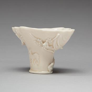 A blanc de chine rhinoserous shaped libation cup, 17th Century.