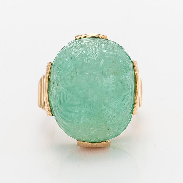 An 18K gold ring with a cabochon-cut emerald, import-stamped A. Tillander.