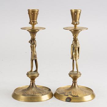 A pair of early 20th century brass candle sticks.