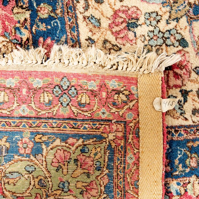 A semiantique Kirman carpet ca 415 x 302 cm.