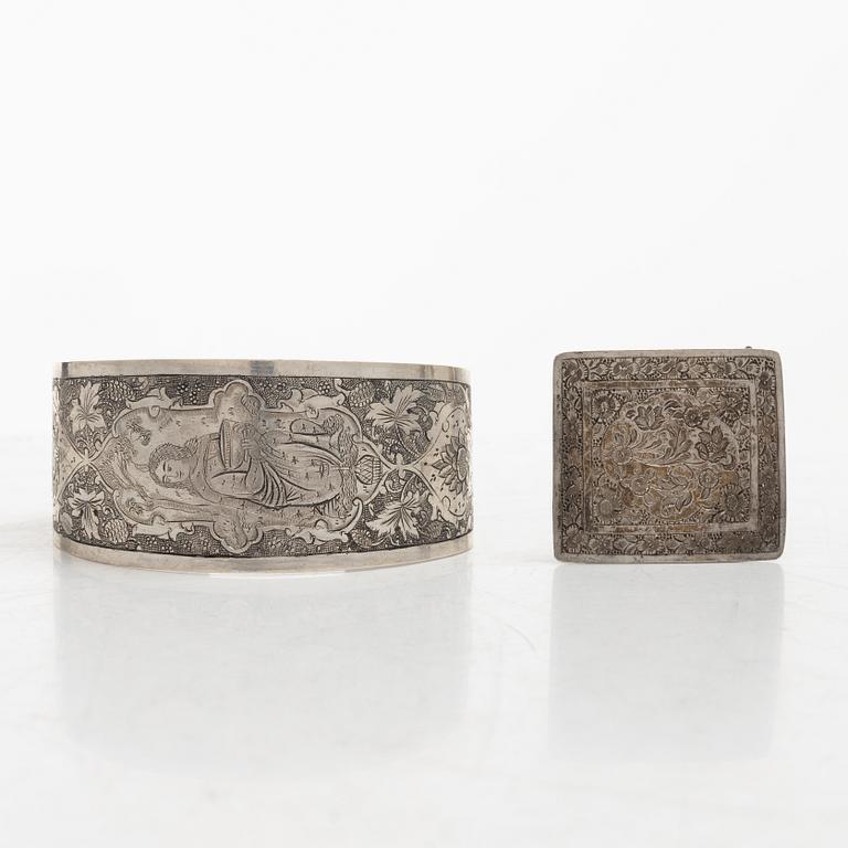 Two silver buttons, a belt buckle, an armring and a box, Persia, first part of the 1900s.