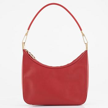 Gucci, a red leather handbag.