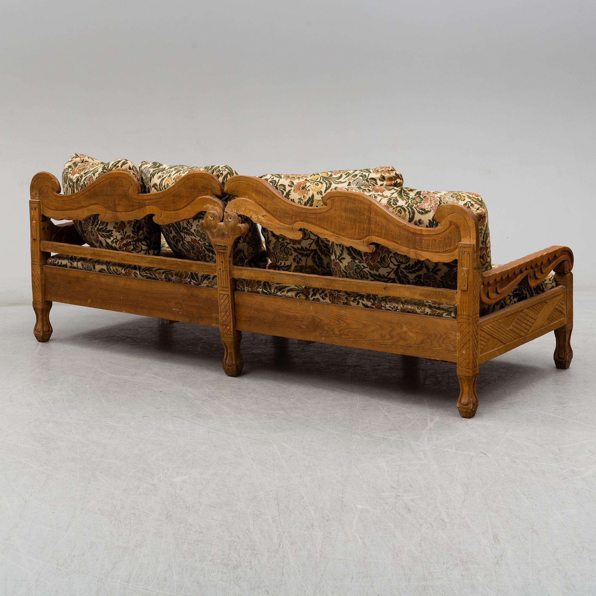 KNUT FJAESTAD, a folk art stained wood sofa/bed,  Sweden, early 20th C.