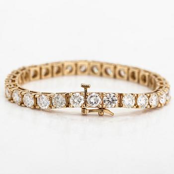 A 14K gold tennis bracelet, with brilliant-cut diamonds totalling approximately 12.00 ct.