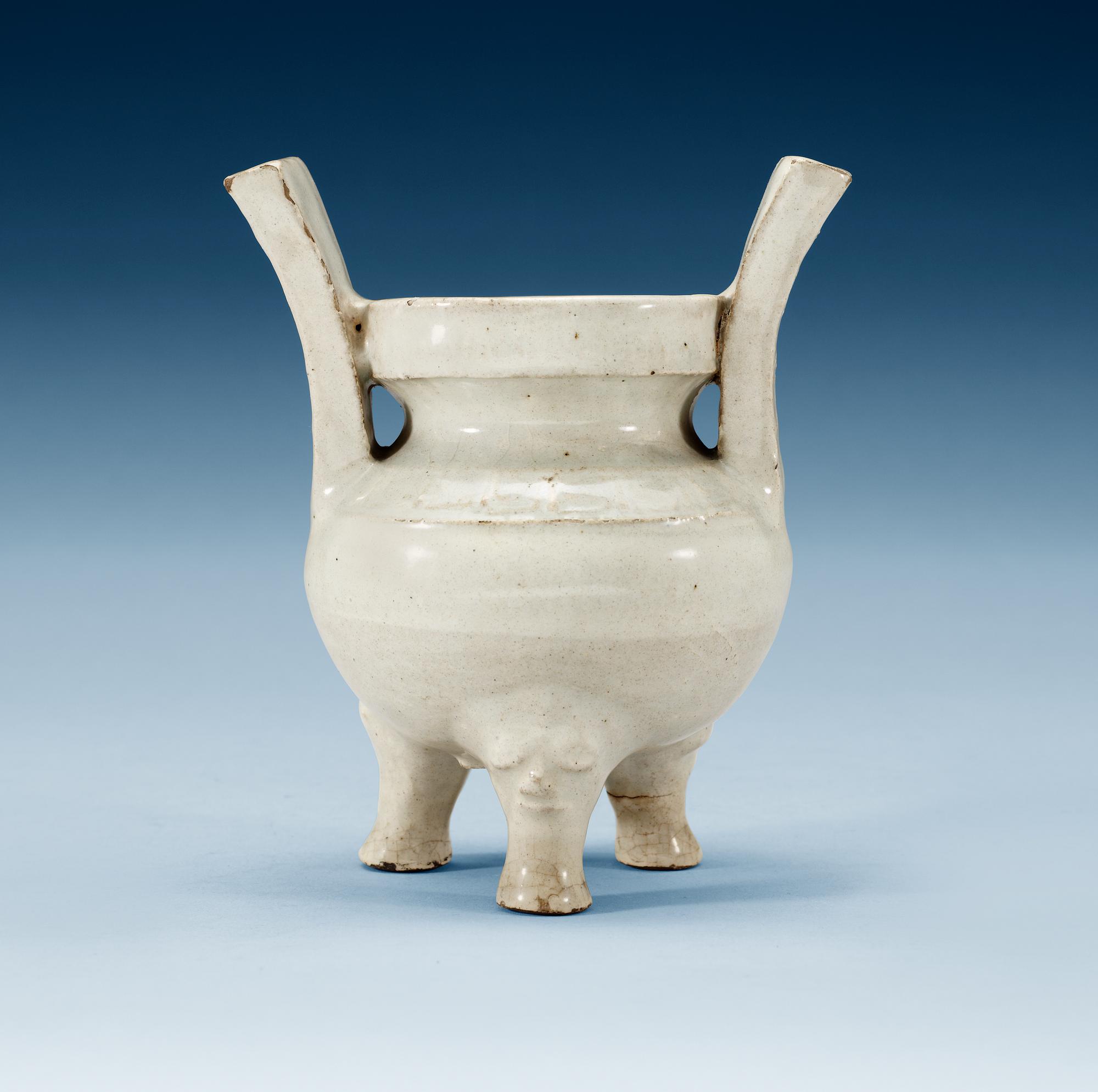 A pale grey-bluish glazed tripod censer with decor in relief, and archaistic mark, Ming dynasty (1368-1644).