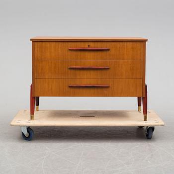 A 1950s teak veneer chest of drawers.