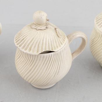 A set of six soft-paste porcelain custard cups with covers, 18th century.
