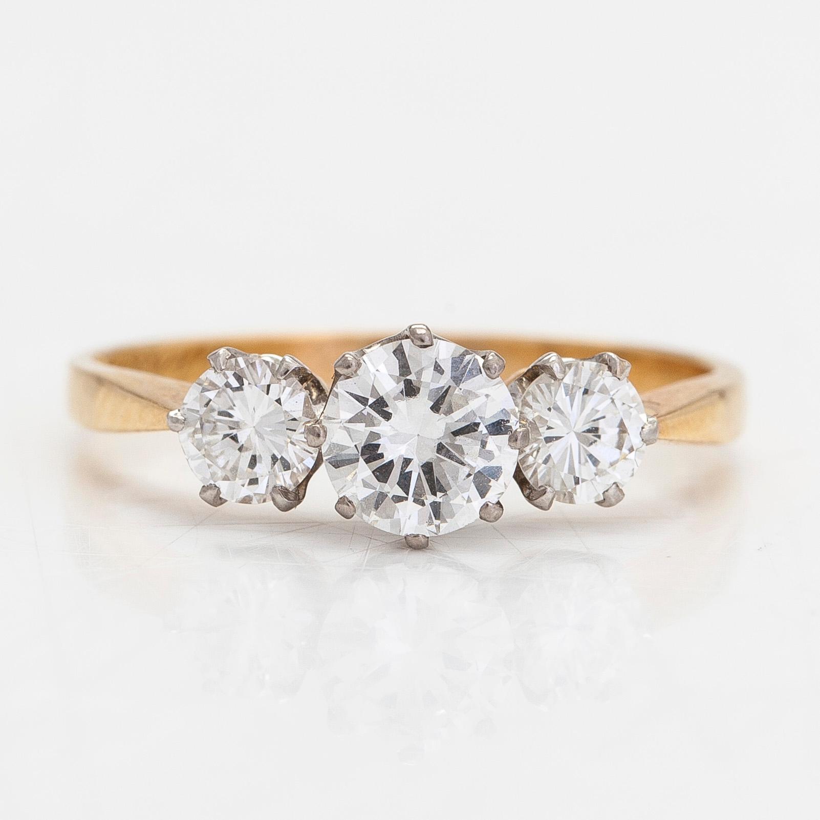 An 18K gold three-stone ring, with brilliant-cut diamonds totalling approximately 1.10 ct. W.Pettersson, Turku.