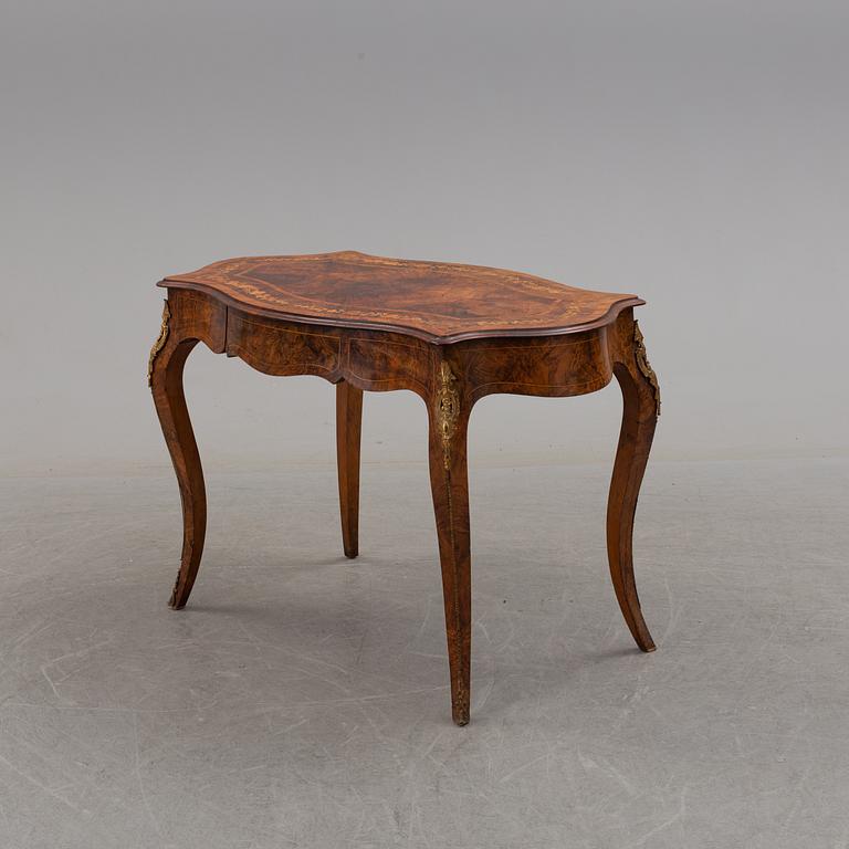 a rococo-style table/desk from England in the late 19th century.