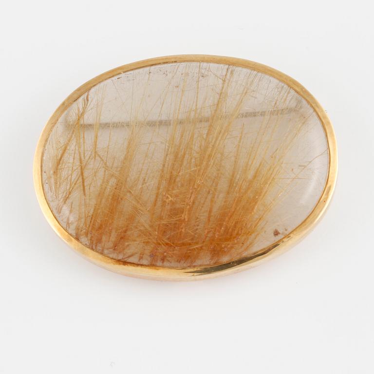 BROSCH, 18K guld med cabochonslipad rutilkvarts. Vikt 17,5 gram.
