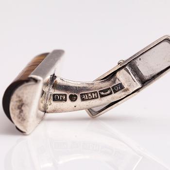A set of three pairs of silver cufflinks with hematite, tigers eye and granite. Turun Hopea and Osvald Mättö.