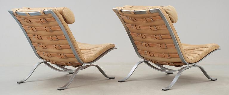 A pair of Arne Norell 'Ari' steel and leather easy chairs, Norell.