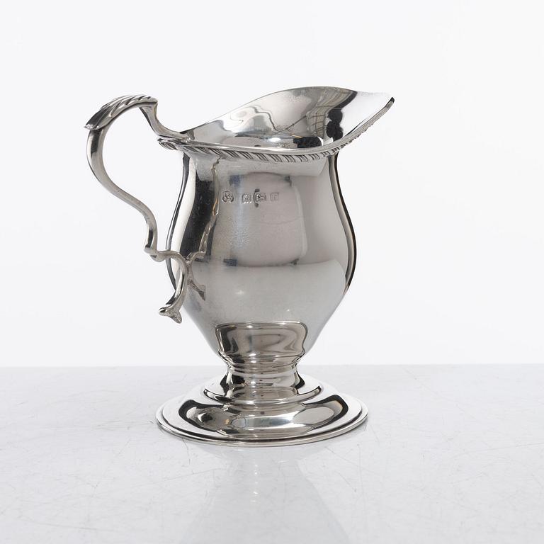 A silver cream jug, mark of S W Smith & Co, Birmingham, England 1929.