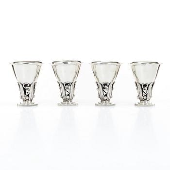 Evald Nielsen, four sterling silver beakers/cups on a foot, Denmark 20th century.