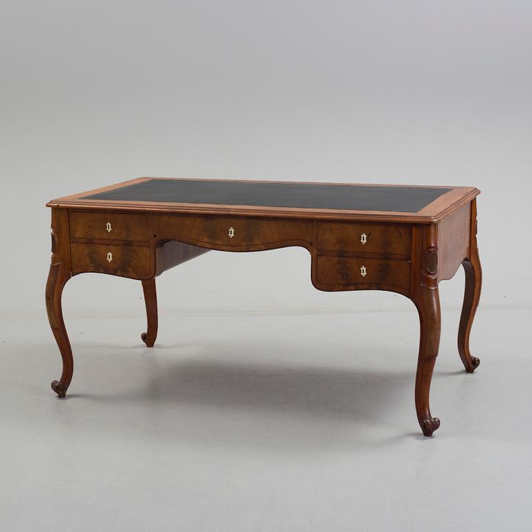 a mahogany rococo-style desk from the second half of the 19th century.