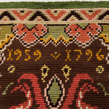 A Finnish folkart long pile Ryijy-rug dated 1959-1796 after Punkalaiduin model. Circa 164 x 125 cm.