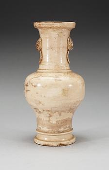 A cream glazed vase, Ming dynasty, with an inscription that dates it to 1608.