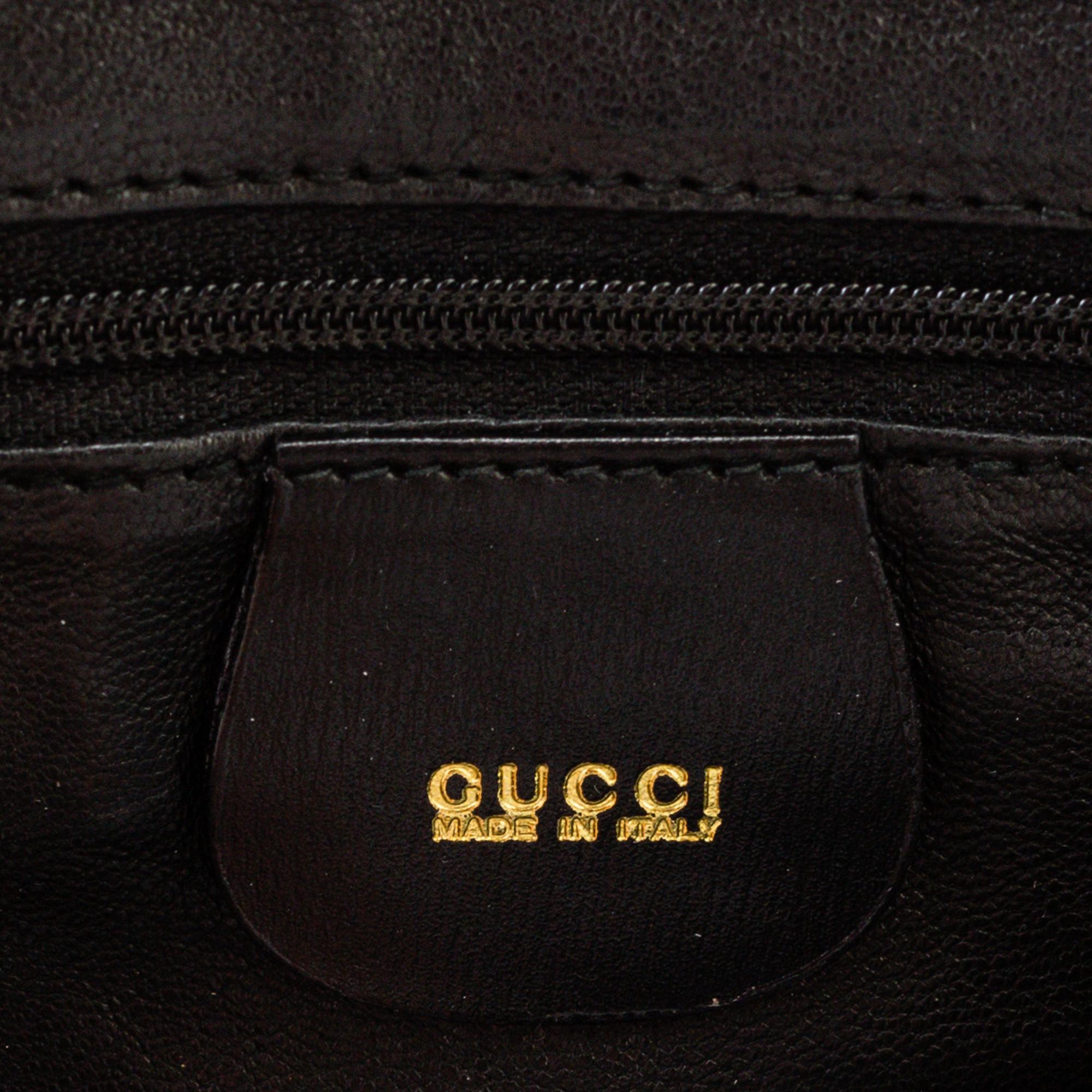A Gucci patent leather bag with bamboo handle.