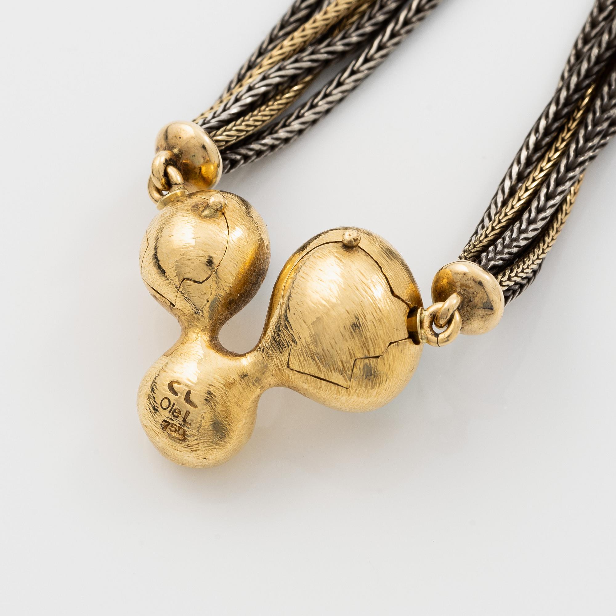 Ole Lynggard lås 18K guld med akvamariner och en rund briljantslipad diamant, design Charlotte Lynggard.
