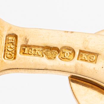 Ett par manschettknappar 18K guld med gröna stenar.