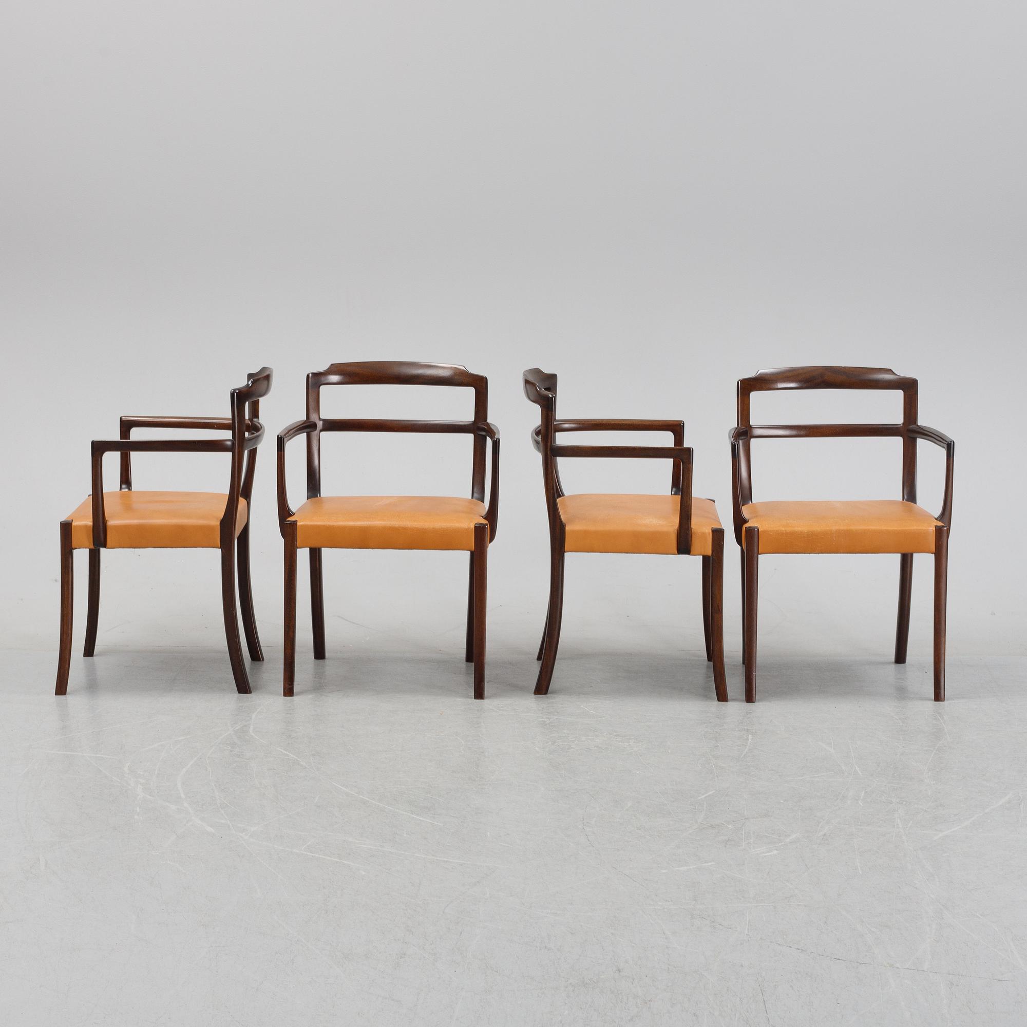 A set of four black stained beech tree arm chairs with leather upholstery, second half of the 20th century.