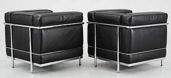 A pair of Le Corbusier 'LC 2' black leather and chromed steel easy chairs, by Cassina, Italy.