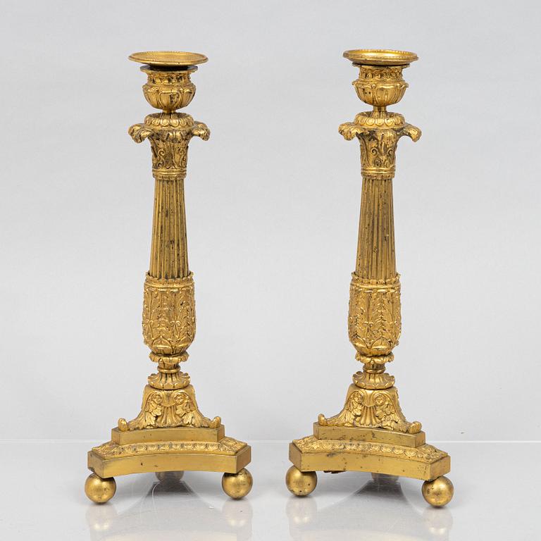 A pair of French Empire gilt-bronze candlesticks, early 19th century,