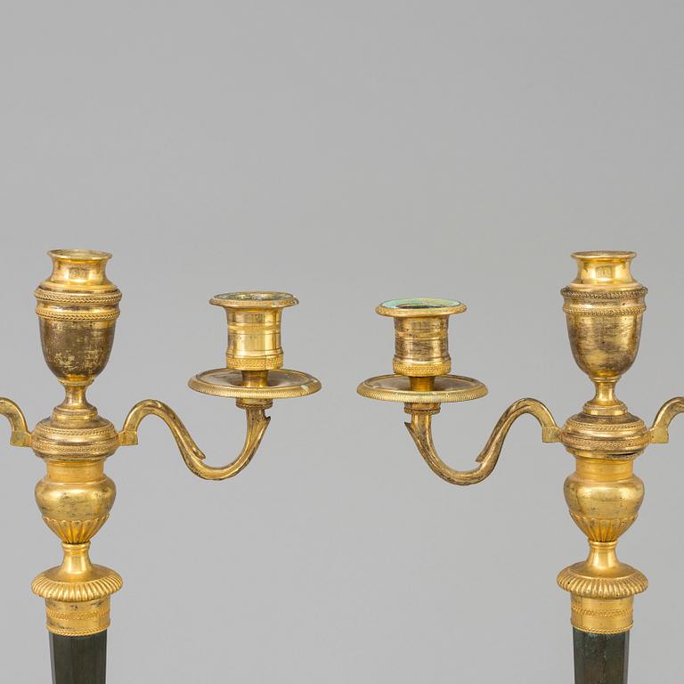 A pair of French Directoire late 18th century ormolu candelabra for three candles.