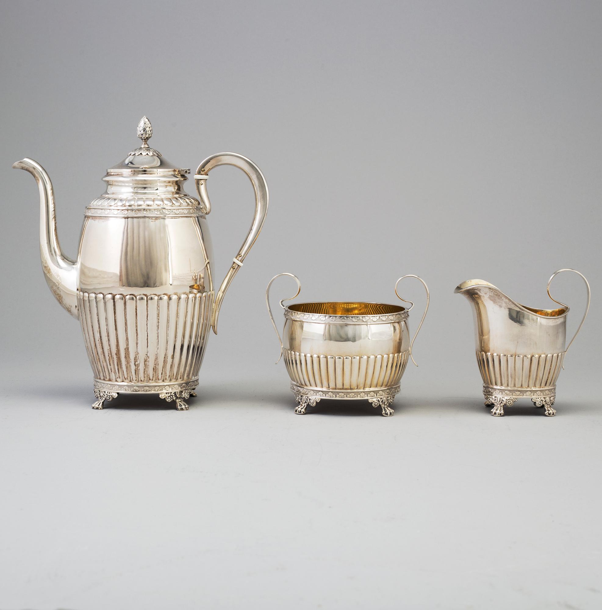 A 3 part silver coffee service dated 1919.