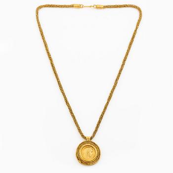 A necklace 18K gold set with a gold coin.