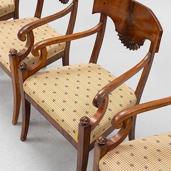 A suite of four Swedish Empire mahogany open armchairs, early 19th century.