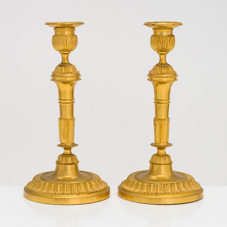 A pair of mid-19th-century gilded bronze candlesticks.