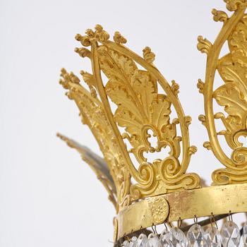 An French Empire eight-light gilt-brass and cut-glass chandelier.