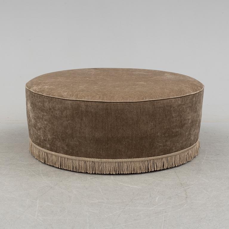 A 21st century upholstered foot stool by Gubi.