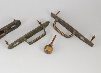 Four bronze art déco door handles, 1930s.