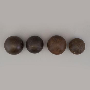 Four iron balls, 18th/19th century.