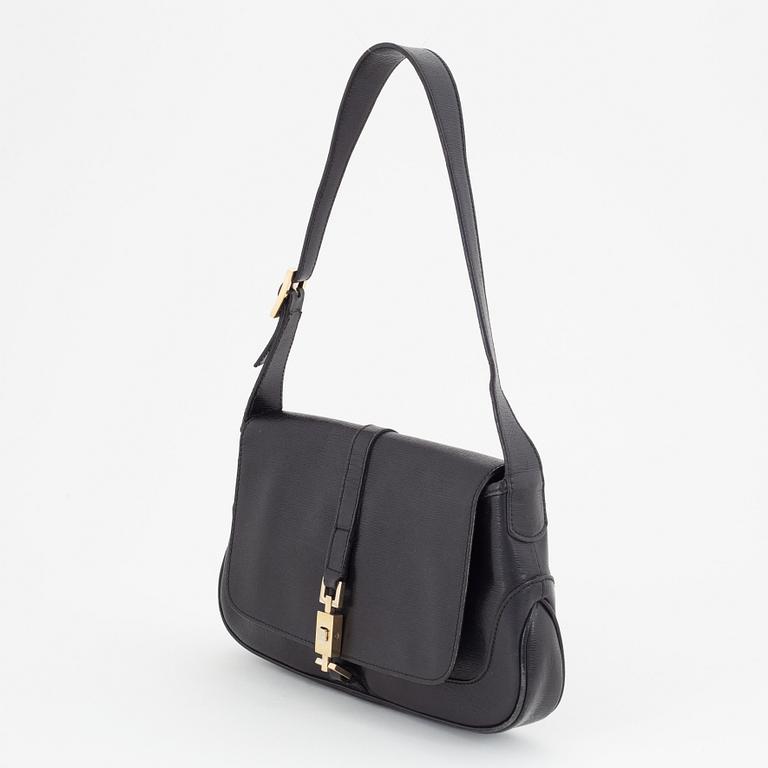 Gucci, a black and gold bag.